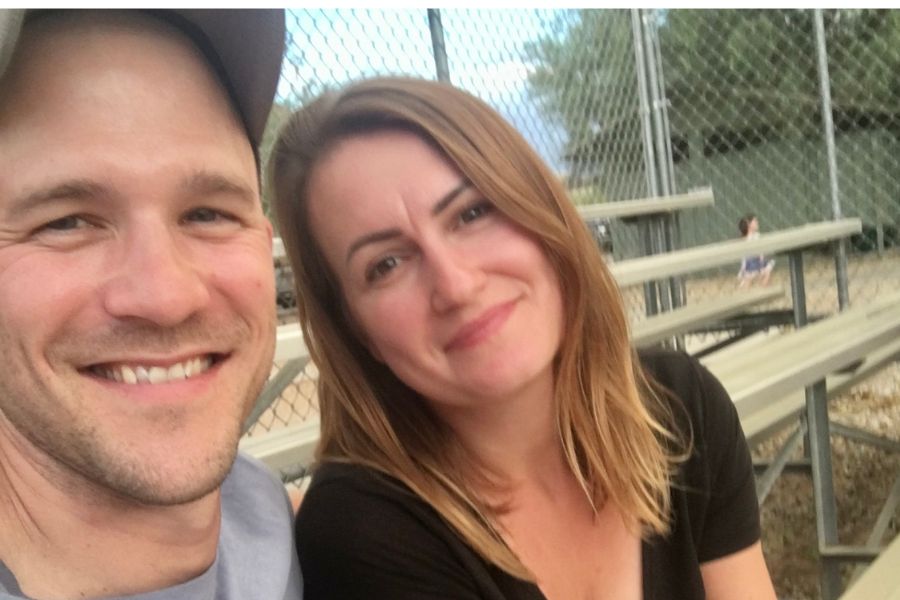 a man and woman sitting on bleachers