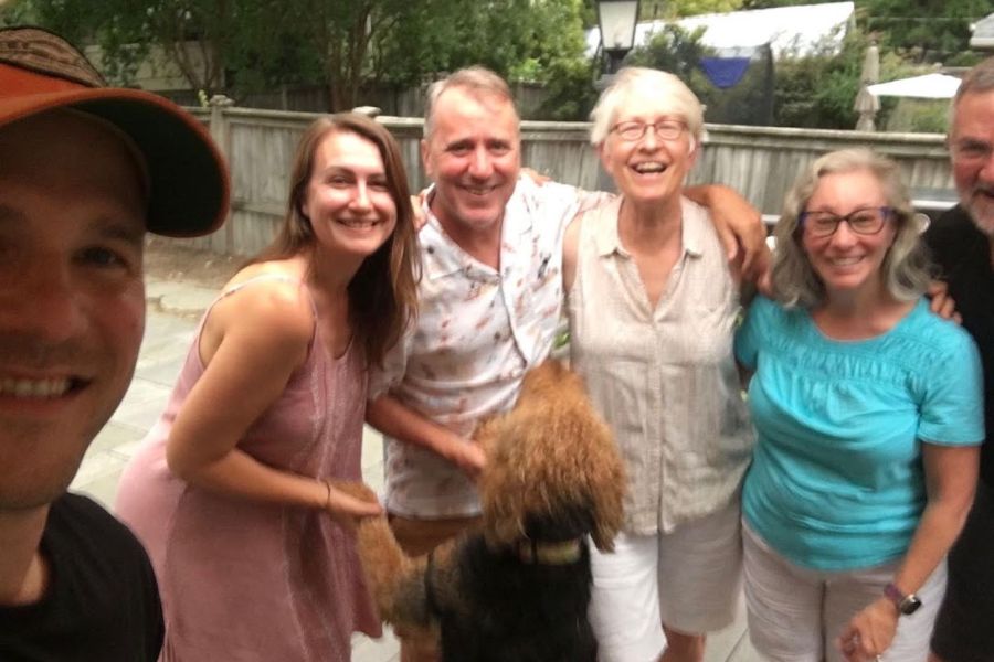 5 adults and an Airedale dog take a happy selfie in Durham, NC