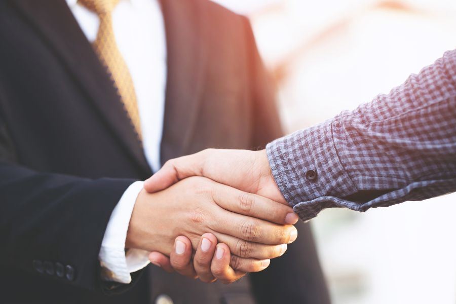 two people shaking hands
