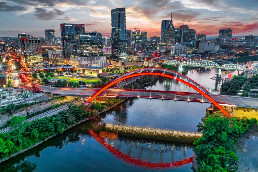 Nashville city skyline. Bridges lit up and skyscrapers as the sunsets over music city