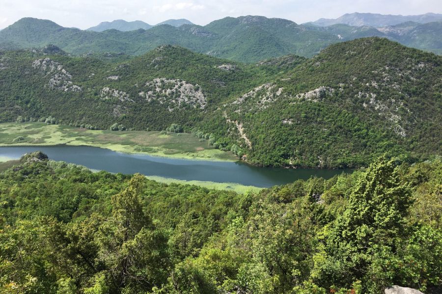 stunning green hilly countryside with a river running through thevalley