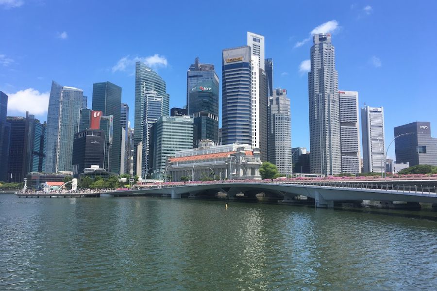 Blue skies over the Singapore skyline. Mulitple skyscrapers lined the picture