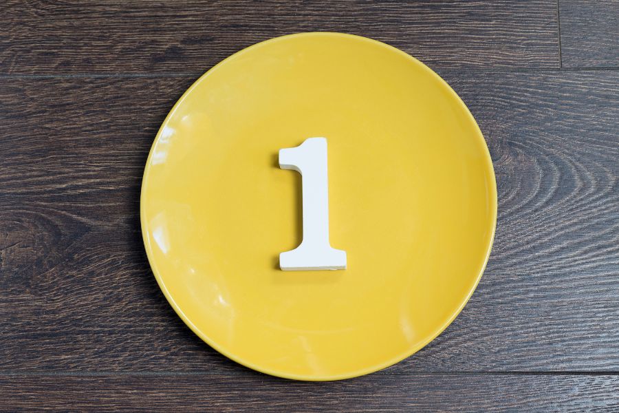 a yellow circular plate with the number 1 placed in the center