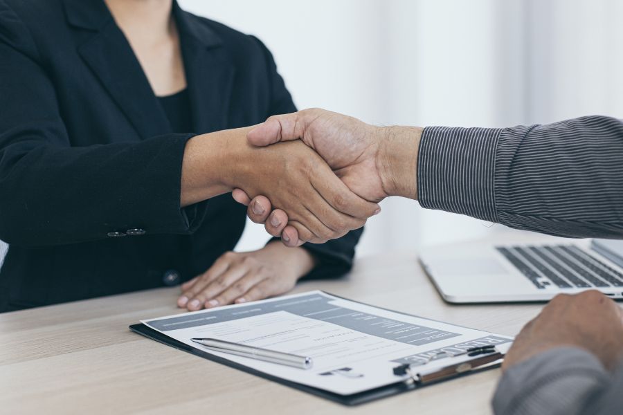 two people shake hands over an agreement