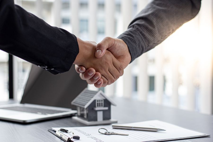 two people shake hands