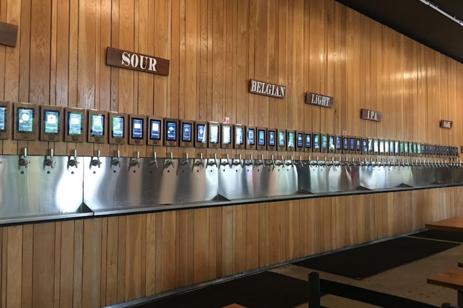 a row of about 30 pour your own beer taps