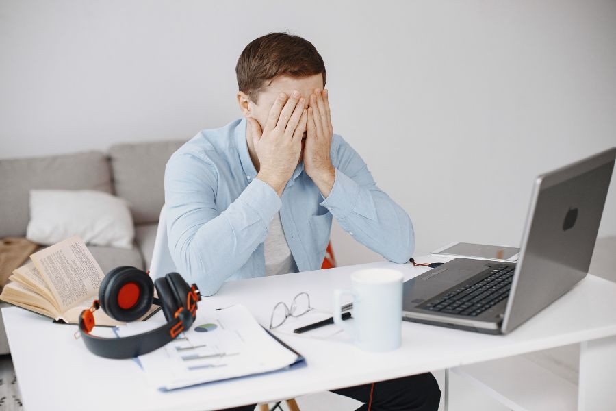 distraught man at a laptop