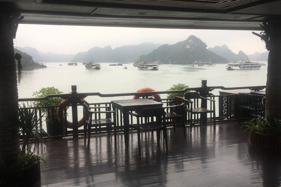 the deck of a ship looking out on to water and other boats