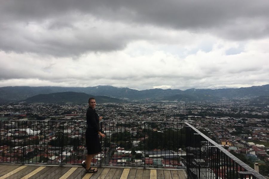 woman stands on rooftop terrace