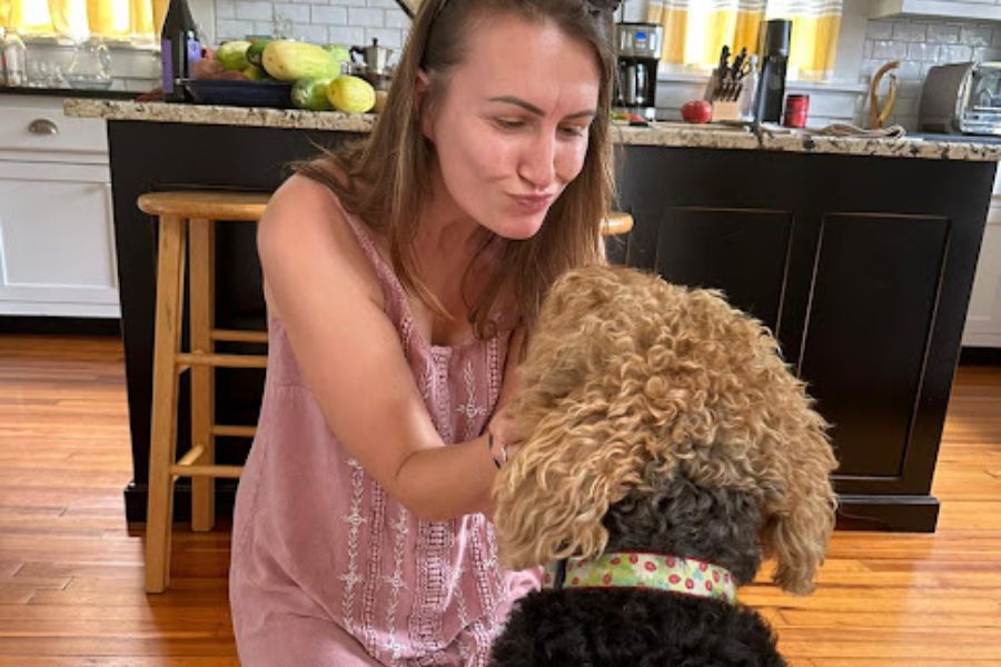 woman embracing Airedale dog