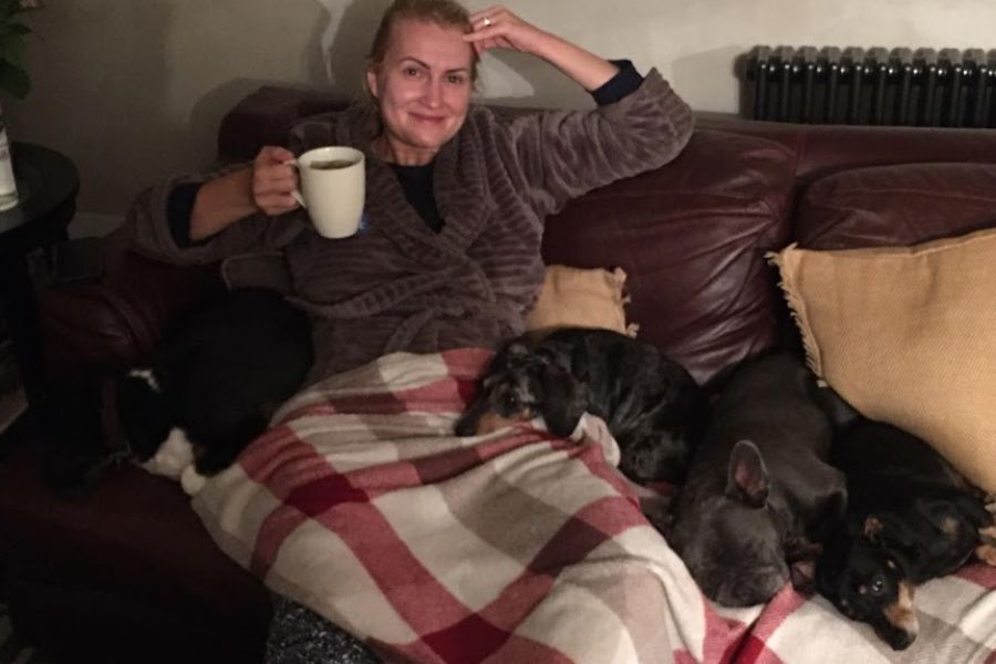 lady on sofa with 4 dogs