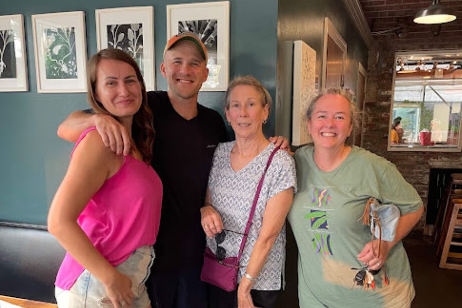 A man and 3 women smile for a photo