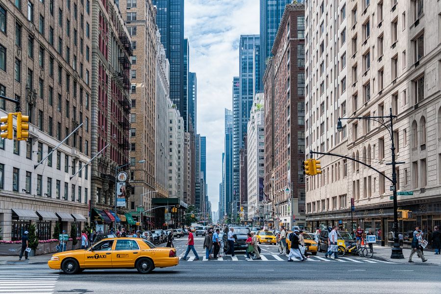 Yellow cab, busy pedestrian crossing central New York City