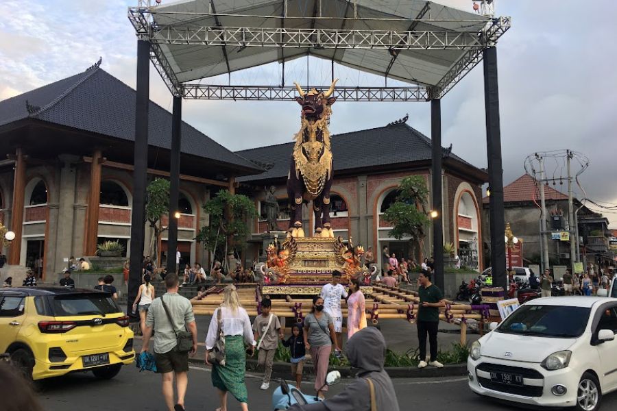 busy street with large monument in the background