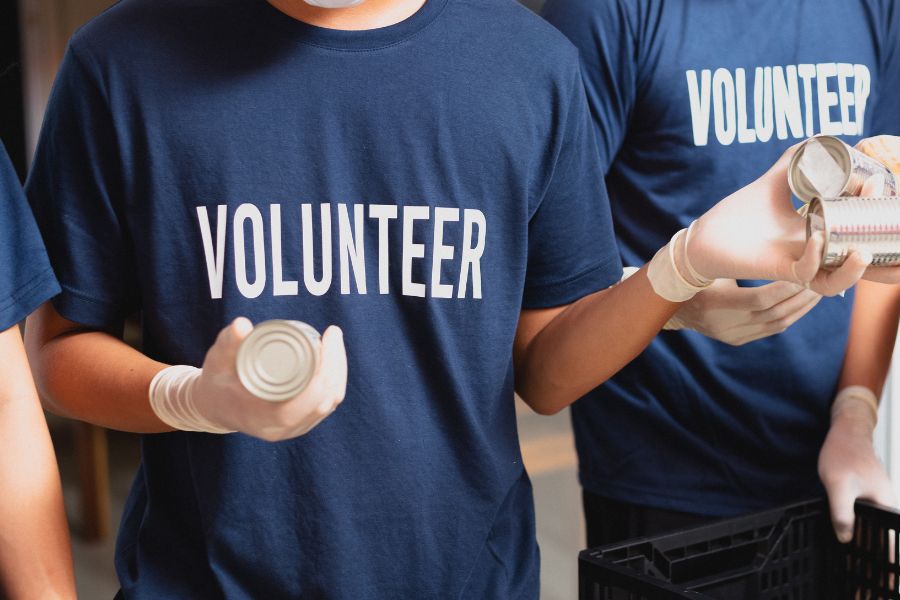 volunteers handing out cans