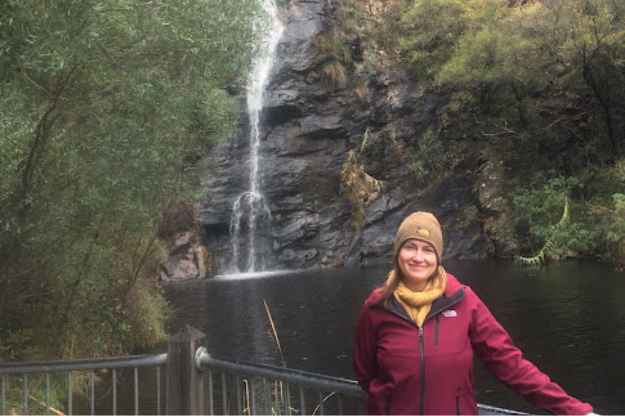 woman in front of waterfall