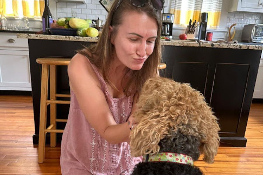 Woman pulls kissy face at a dog