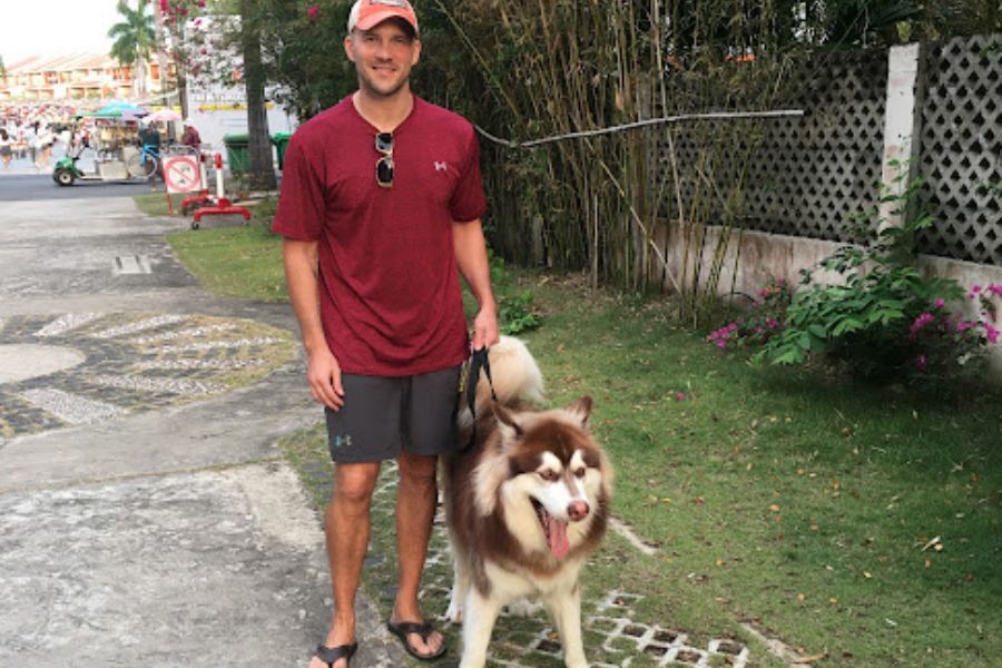 man and large dog go for a walk