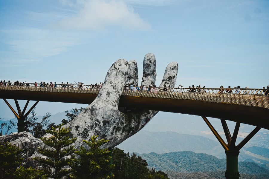 Large hand statue holds up a bridge 