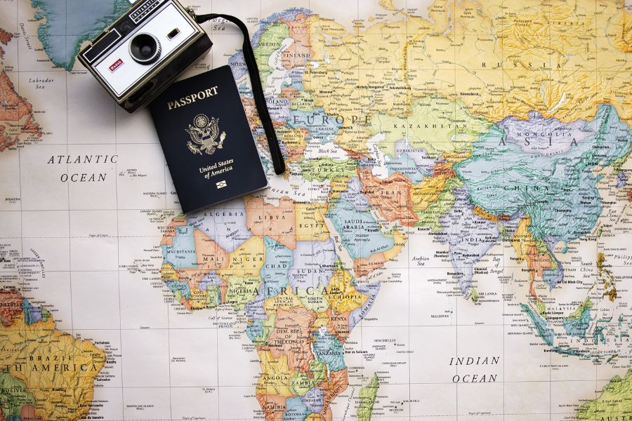 map, passport, and camera