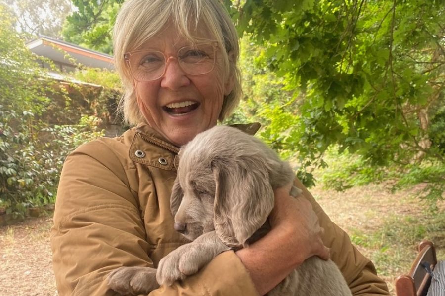 woman holding puppy