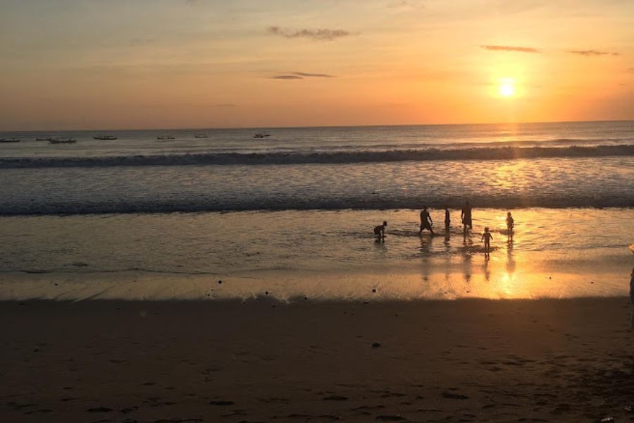 The sun sets on Kuta Beach