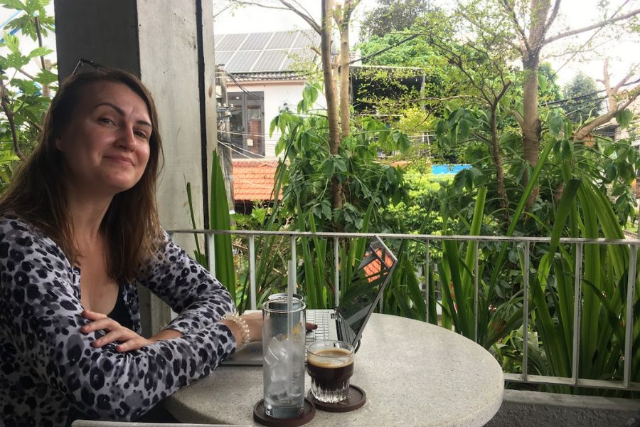 woman working at a laptop in a cafe