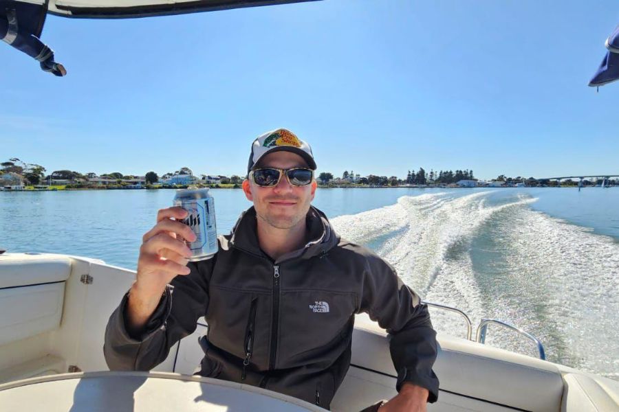 man on boat with a beer