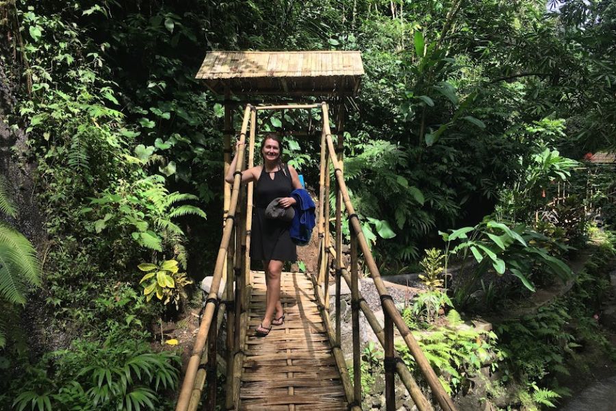 woman on wooden bridge in the jungle