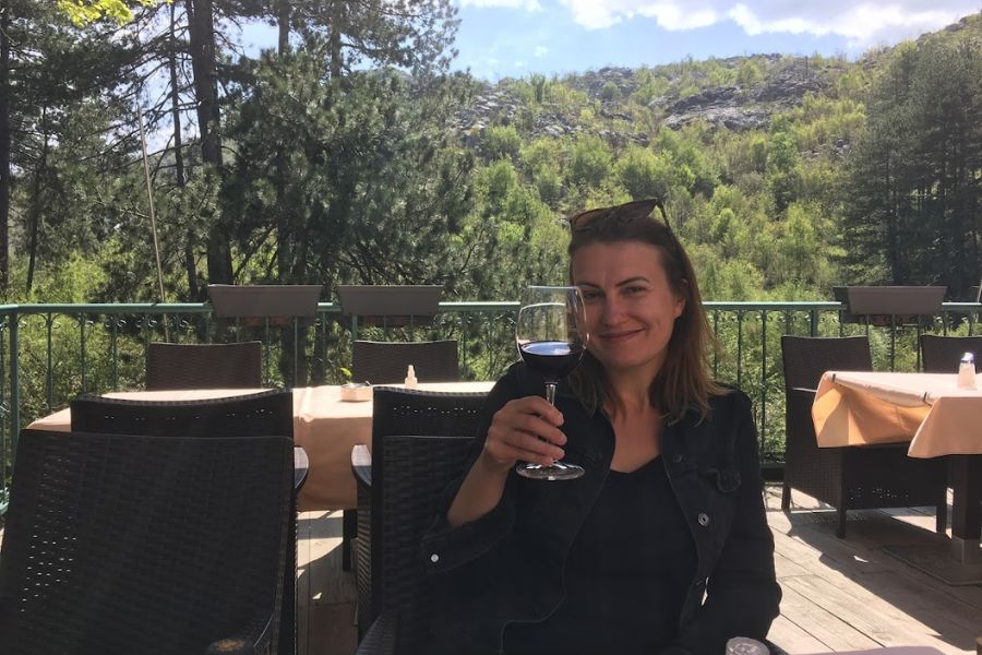 woman toasts a glass of wine