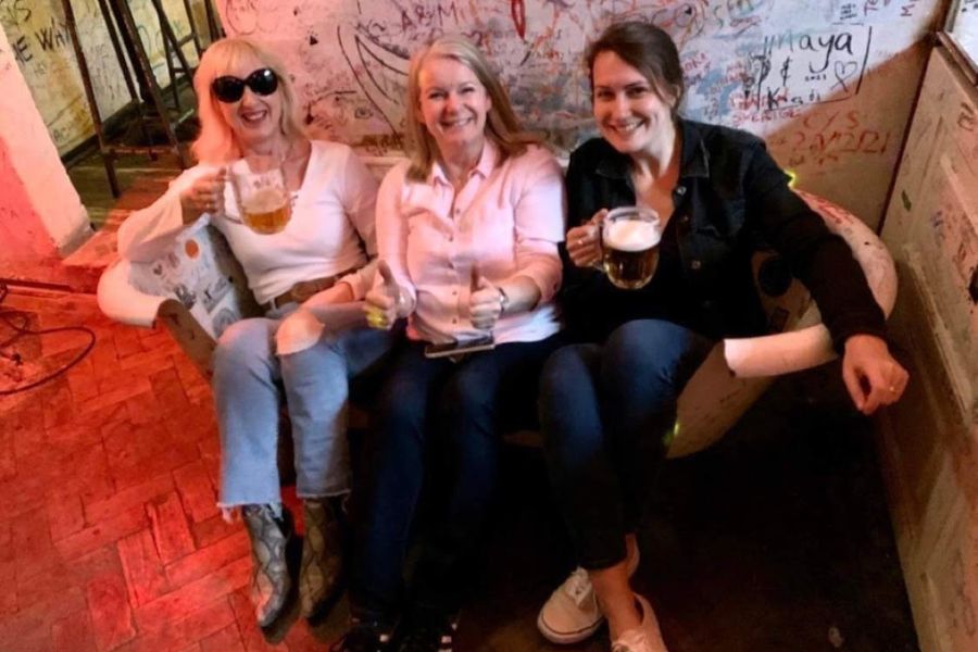 3 women drinking in a repurposed bathtub