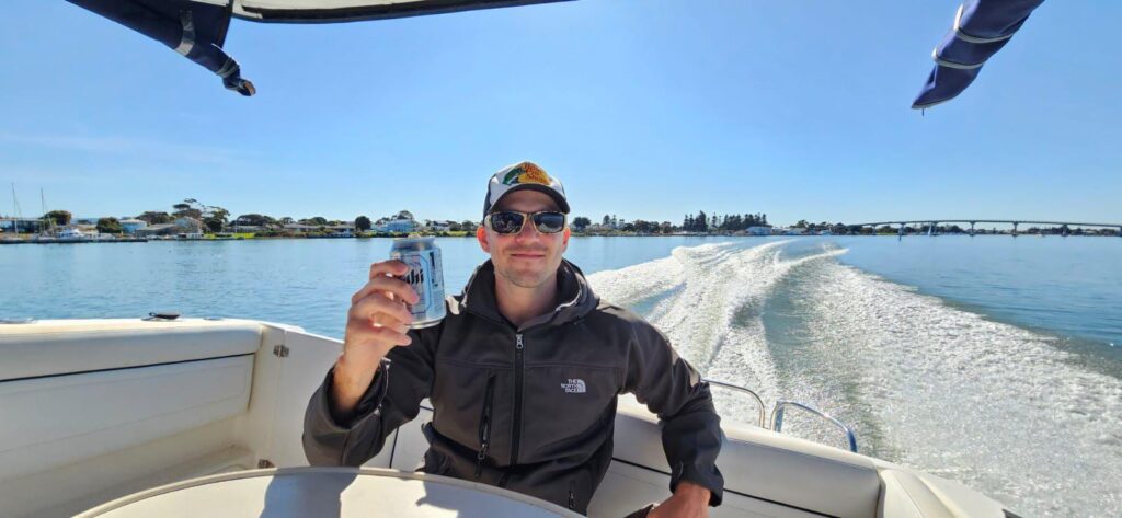 man on a boat with a beer